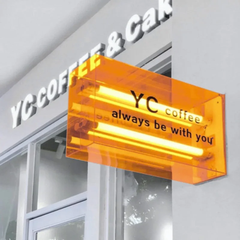 Projecting translucent acrylic lightbox billboard with LED tube lights mounted on a shop wall