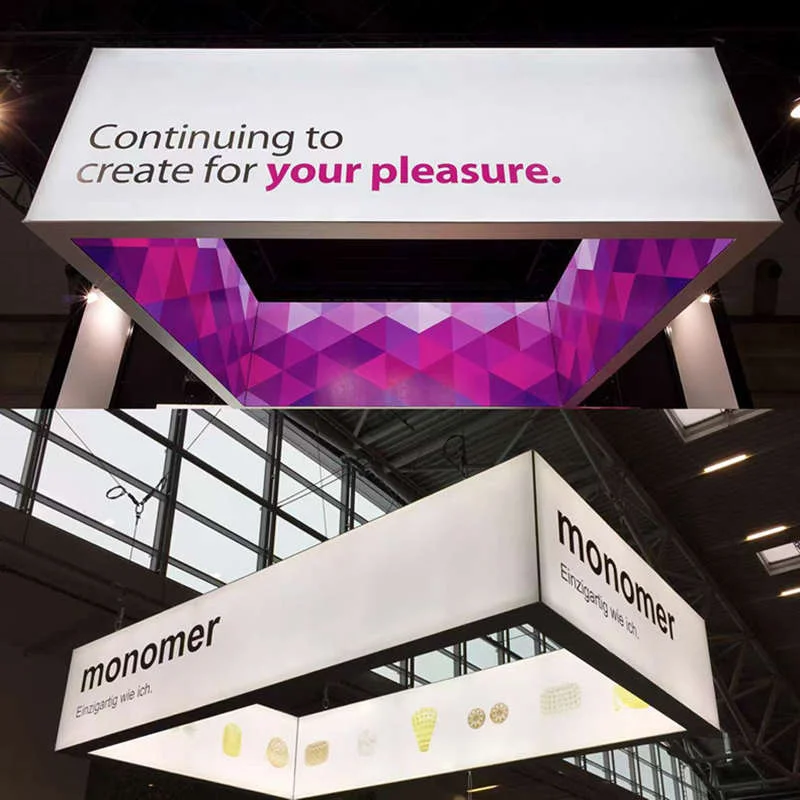 Ceiling hanging fabric lightbox banner suspended above an exhibition hall