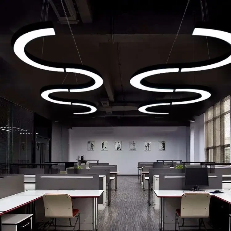 Curved and looping suspended LED linear lights over an office work area