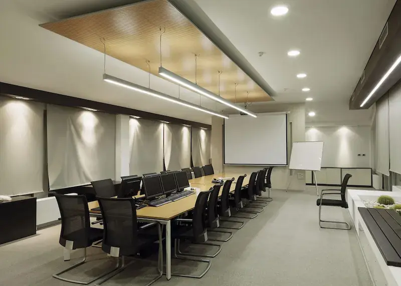 Suspended LED linear lights installed in an office meeting room